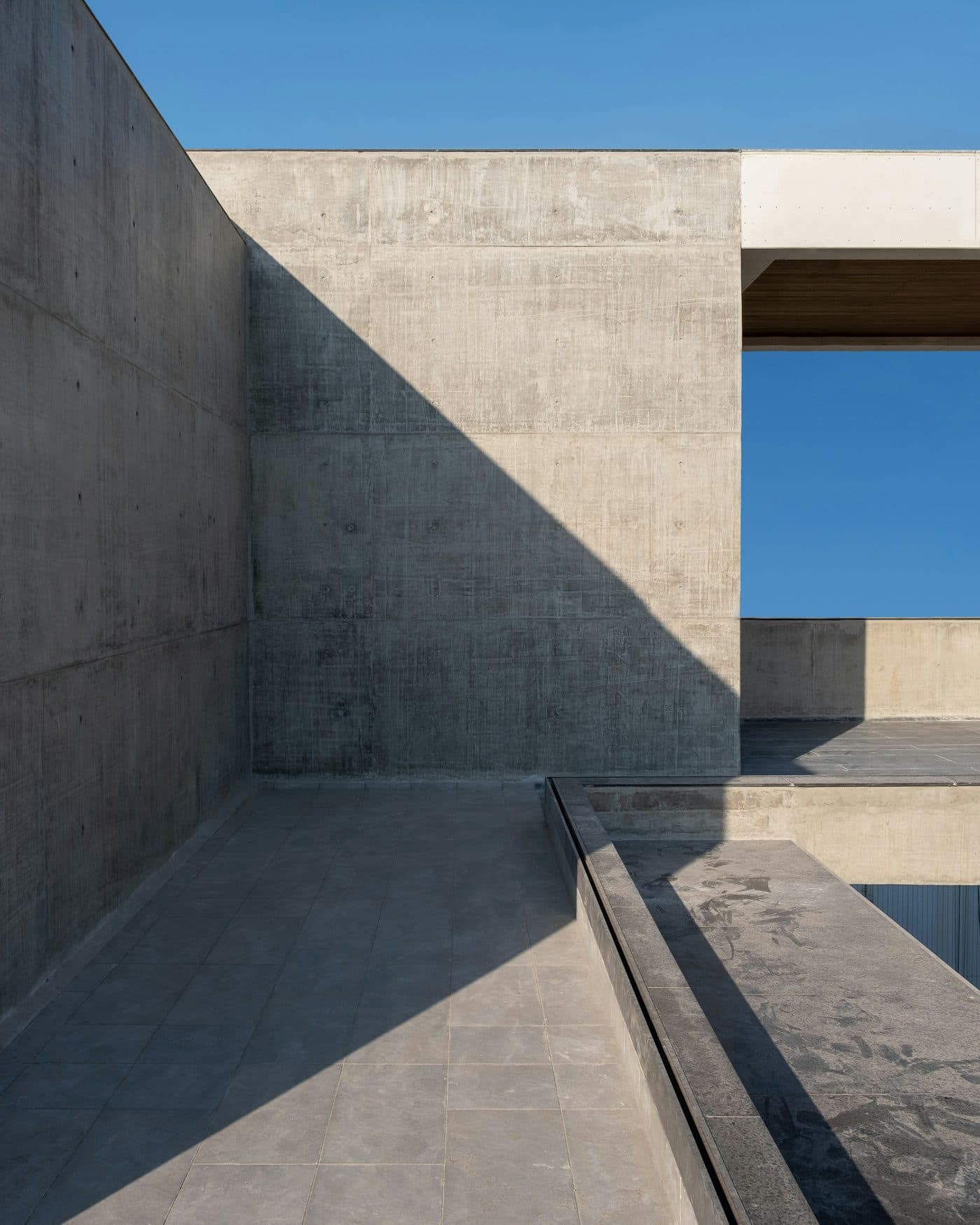 Board-formed concrete wall with the grain of the shuttering still visible.