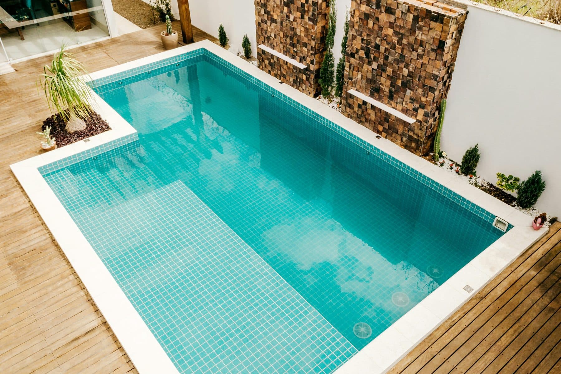 The pool at midday, andesite coping level with the water.