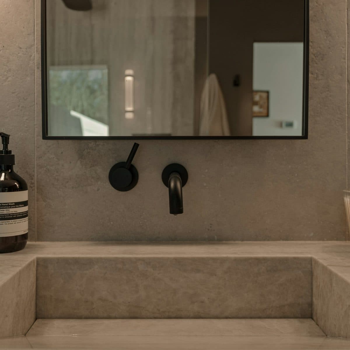A stone basin set into a teak vanity in the master bathroom.