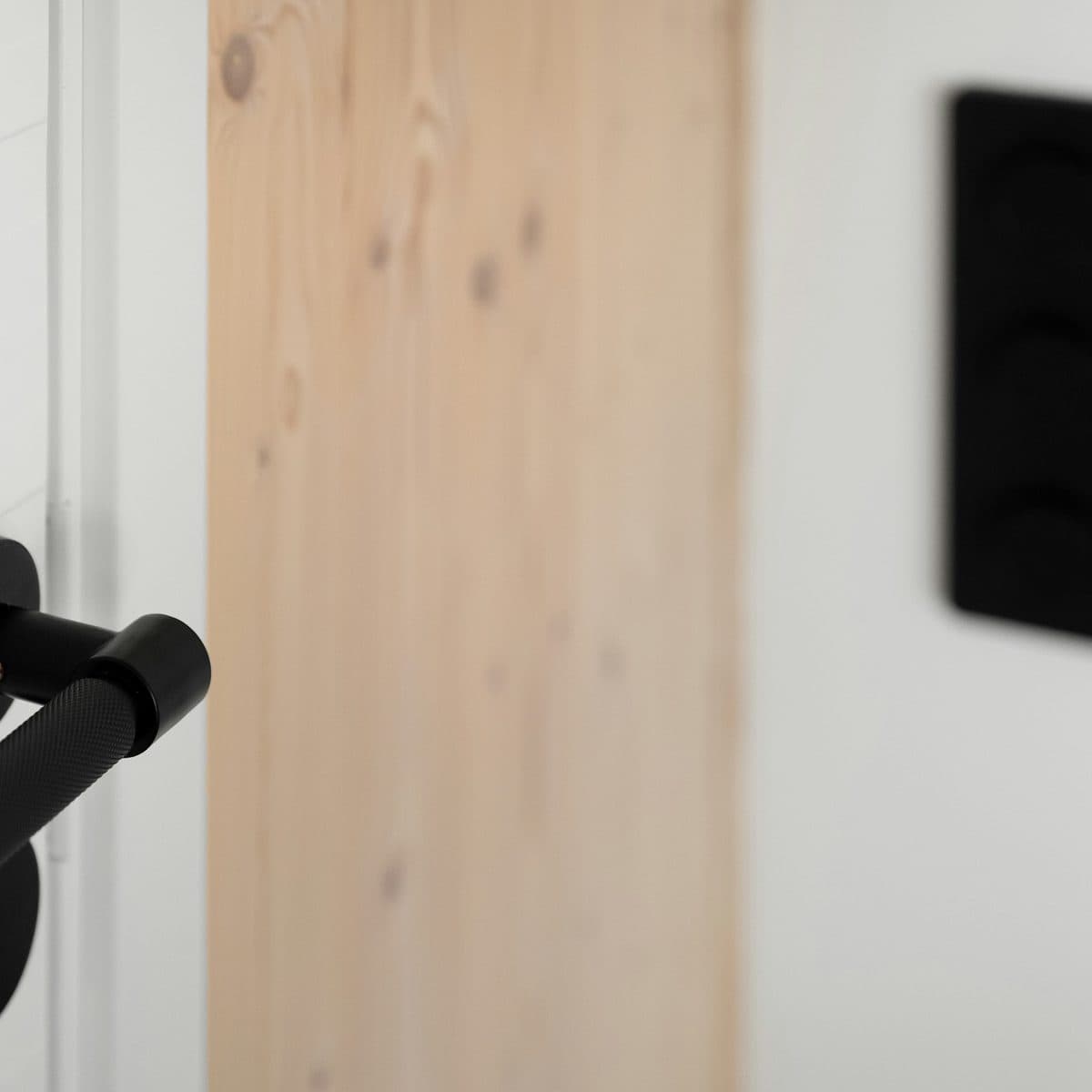 Detail of a lever handle on a timber door.