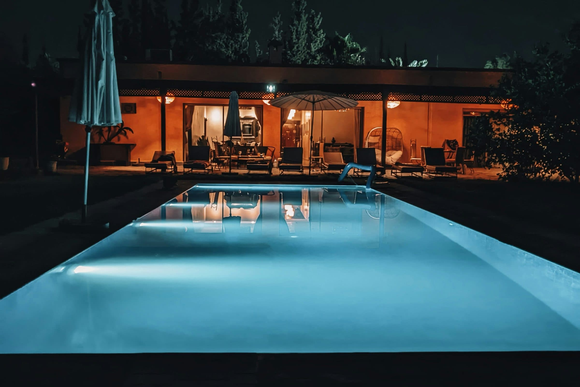 Late afternoon on the terrace: two loungers in shade, the pool taking the last of the light.